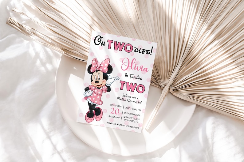 May include: A pink and white invitation card featuring Minnie Mouse, with the text "Oh Two Dles!" and "Olivia is turning two." The card includes event details like date, time, and location, with a polka dot background.