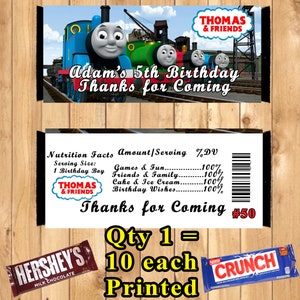 May include: A blue and red candy bar wrapper with the text "CRUNCH" in white. The wrapper is next to a yellow sign with the text "Qty 1 = 10 each Printed". The sign is above a blue and white candy bar wrapper with the text "HERSHEY'S MILK CHOCOLATE". The top of the image shows a blue and red banner with the text "THOMAS & FRIENDS Adam's 5th Birthday Thanks for Coming". Below the banner is a white rectangle with the text "Nutrition Facts Amount/Serving %DV Serving Size: 1 Birthday Boy THOMAS & FRIENDS Games & Fun......100% Friends & Family......100% Cake & Ice Cream..........100% Birthday Wishes............100% Thanks for Coming #50"