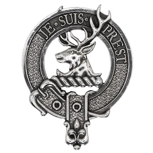 May include: A silver-toned metal clan crest featuring a stag with antlers, a rope design, and the text "JE SUIS PREST".