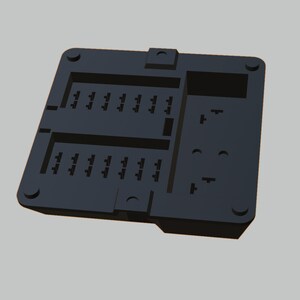 May include: A black plastic fuse box with multiple slots for fuses. The fuse box has a rectangular shape and is designed to hold fuses.