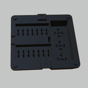 May include: Black plastic fuse box with 16 slots for fuses. The fuse box has a label that reads "1/2" and "1/4" on the right side.