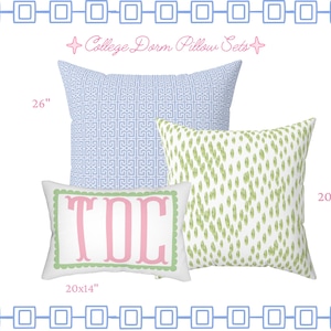 May include: A set of three decorative pillows labeled College Dorm Pillow Sets. One large square pillow features a blue geometric pattern measuring 26 inches, a square pillow with a green speckled print measuring 20 inches, and a rectangular pillow with the pink monogram TDC measuring 20x14 inches.