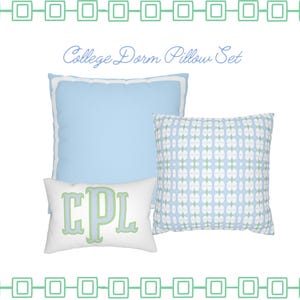 May include: A three-piece pillow set featuring a solid light blue square pillow with white piping, a square pillow with a light blue and white geometric pattern, and a white rectangular lumbar pillow with the green monogram letters CPL.