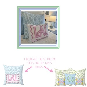 May include: A close-up of a pink pillow with the letters "LAL" in a white outline. The pillow is on a bed with a blue and white patterned pillow behind it. The text "I designed these pillow sets for my girls' rooms." is below the image.