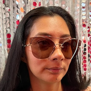 Miu Miu Women’s Designer Sunglasses – Gold Frame with Rose Lenses, Chic Cat-Eye Style, Luxury Eyewear