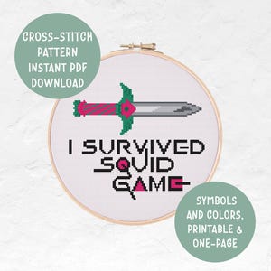 May include: Cross-stitch pattern featuring a sword and the text "I Survived Squid Game" in black. The design is in a wooden embroidery hoop. Includes the text "Symbols and Colors, Printable & One-Page".