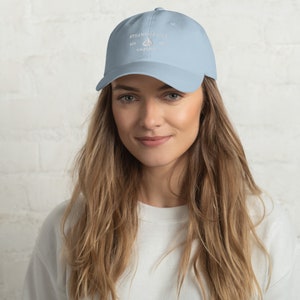 May include: A light blue baseball cap with white embroidery that reads "Stillwater Cove Est. 1981 California".