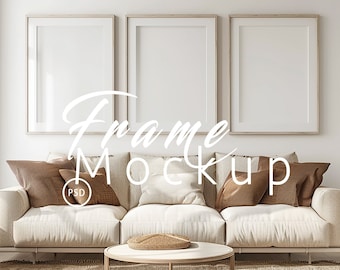 May include: A white couch with brown pillows sits in front of a white wall with three empty picture frames. The couch is on a beige rug. The frames are 11.8 inches by 15.7 inches.