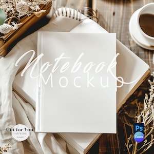 May include: A white notebook mockup with the text "Notebook Mockup" in white cursive font. The notebook is on top of a stack of books and a white cloth. There are dried flowers and a cup of coffee in the background.