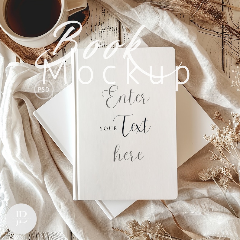 May include: A white book mockup with the text "Book Mockup" and "Enter Your Text Here" on a white background with a beige fabric and dried flowers.