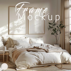 May include: A bedroom scene featuring a bed with white bedding and a tan throw blanket. Two framed mockups hang above the bed. The room is decorated in neutral tones with a small plant and a side table.