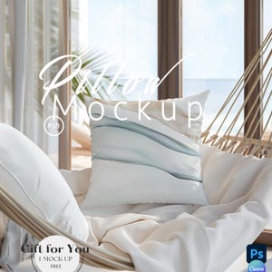 May include: A white square pillow with a blue and beige abstract design, placed on a hammock with white bedding. The words "Pillow Mockup" are written on the pillow. The image is set against a backdrop of a window overlooking the ocean.