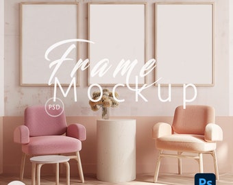 May include: Three wooden picture frames with white mats and blank canvases, hanging on a pink wall. Two pink and orange armchairs are in front of the frames, with a small white table in front of the pink chair and a larger white table in front of the orange chair. A vase with dried flowers sits on the larger table. The text "Frame Mockup" is written in white on the wall.