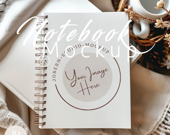 May include: A white notebook with a spiral binding and a brown circle with the text "Your Image Here" in the centre. The notebook is on a white surface with a brown woven basket and a white mug.