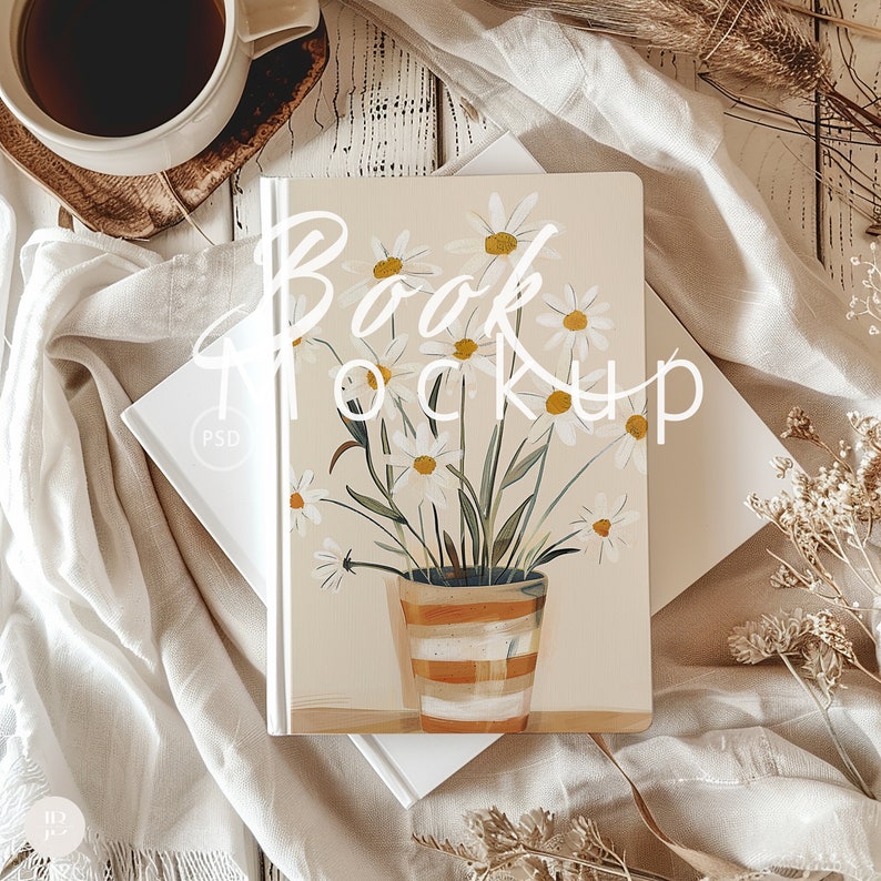 May include: A white book mockup with a floral design on the cover. The design features a bouquet of white daisies in a striped orange pot on a beige background. The text "Book Mockup" is written in white on the cover.