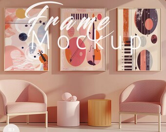 May include: Three framed abstract art prints with geometric shapes and musical instruments in pink, red, blue, and black colors. The prints are hanging on a light pink wall with two pink armchairs and two side tables.