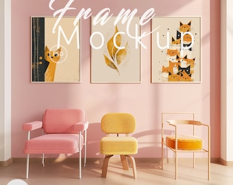 May include: Three framed illustrations on a pink wall. The illustrations are of a cat, a stylized leaf, and a stack of cats. The wall is in a living room with three chairs, one pink, one yellow, and one gold.