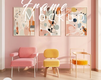 May include: Three framed abstract art prints with a pink, peach, and blue color scheme. The prints feature a violin, musical notes, and geometric shapes. The frames are hanging on a pink wall in a living room setting with three chairs.