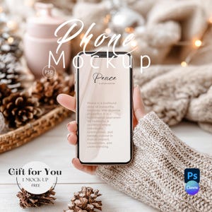 May include: A smartphone mockup displaying the word "Peace" on the screen. The phone is held by a person wearing a beige sweater. The background features pine cones, a decorative basket, and the text "Phone Mockup".