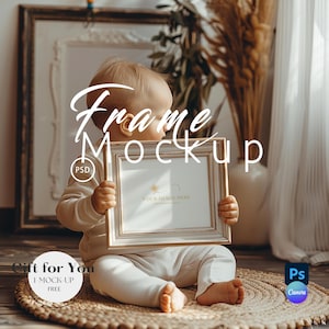 May include: A baby holding a rectangular, ornate, off-white picture frame mockup. The frame has a gold-colored trim. The text "Frame Mockup" is overlaid on the image, along with "Your Image Here". The baby is sitting on a woven mat.