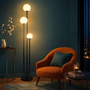 May include: A tall floor lamp featuring a slender black metal frame with three vertical poles of varying heights, each topped with a glowing white spherical glass globe. The lamp stands on a circular black base and emits a warm, soft light.
