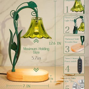 May include: A decorative table lamp with a green metal floral design and a yellow glass lampshade. The lamp has a wooden base and measures 12.6 inches high. The maximum holding size is 5.7 inches, and the base is 7 inches wide.