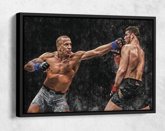 May include: Two mixed martial arts fighters in a boxing match. The fighter on the left is wearing black shorts with the UFC logo and a blue and white glove. The fighter on the right is wearing black shorts with a white and gold logo and a blue glove. The background is a dark gray with a grunge effect.