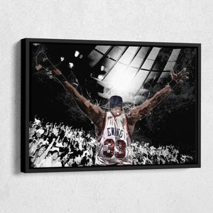 May include: Black and white illustration of a basketball player with arms raised in victory. The player is wearing a white jersey with the name "Ewing" and the number "33" on the back. The player is surrounded by a crowd of people.
