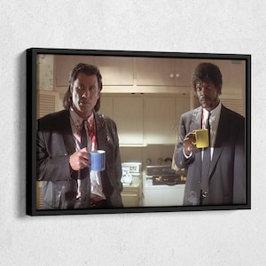 May include: Two men in suits, one with a blue mug and the other with a yellow mug, stand in a kitchen with white cabinets and a washing machine. Both men have white powder on their suits and one man has blood on his shirt.