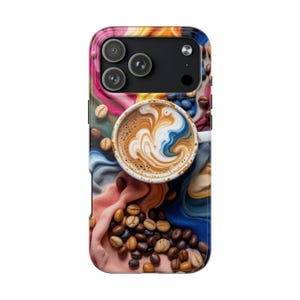 May include: A smartphone case featuring a coffee theme. The case has a colorful abstract background with a cup of latte art and scattered coffee beans. The phone's camera lenses are visible at the top.