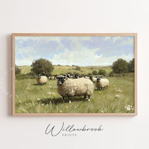 May include: A framed print of a pastoral scene featuring a flock of sheep grazing in a green field under a blue sky. The sheep have white wool and black faces. The artwork has a soft, painterly style with visible brushstrokes.