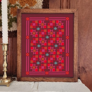 Puede incluir: Una impresión enmarcada con un patrón geométrico en tonos de rojo, rosa y naranja, acentuada con estrellas turquesas. La obra de arte está encerrada en un marco de madera marrón oscuro, creando una estética vintage. La impresión se muestra sobre una superficie blanca.