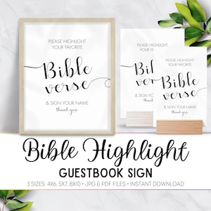May include: A framed white sign with the words "Bible verse" in elegant script, accompanied by smaller text. Additional signs and a wooden block are also visible. The bottom of the image reads "Bible Highlight GUESTBOOK SIGN".