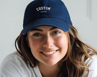 May include: A person wearing a navy blue baseball cap with white embroidered text that reads "CUSTOM text here".