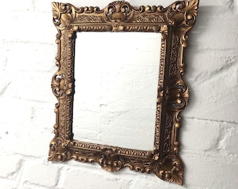 Italian retro mirror with plastic frame in Rococo style, 1980s. Outer dimensions: 37 x 44 cm / Mirror: 22 x 29 cm