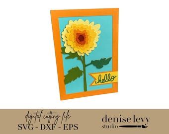 Può includere: Un biglietto floreale di carta a strati con un motivo a girasole giallo e arancione. Il fiore è centrato su uno sfondo azzurro, incorniciato da un bordo arancione. Un gambo e foglie verdi sostengono il fiore. La parola "hello" è su uno striscione giallo.
