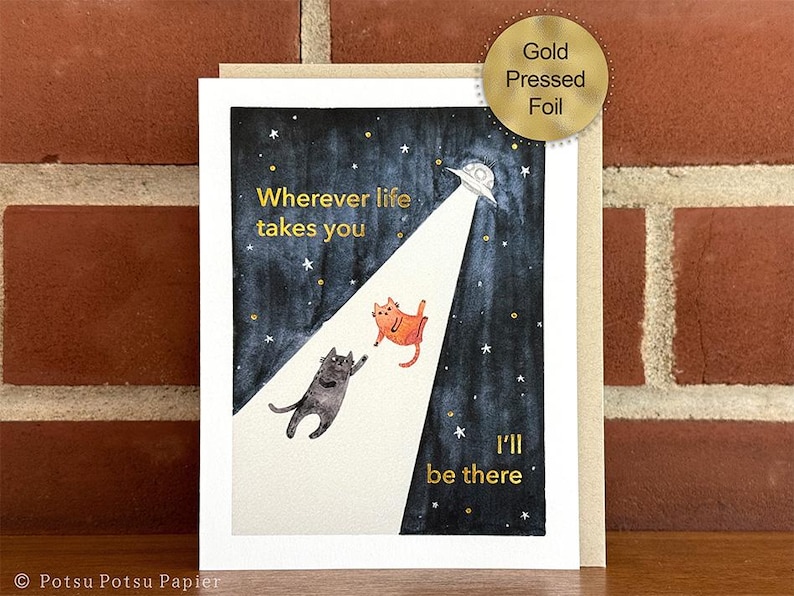Greeting card of hand painted illustration of two cats sitting on a fence and looking up at the moon. Message and embellishments in gold pressed-foil.

Message: Wherever life takes you I'll be there.

Includes a2 kraft envelope.