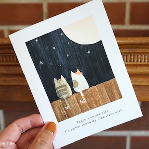 Close up of greeting card with hand painted illustration of two cats sitting on a fence and looking up at the moon.

Message: There's no one else I'd rather spend my nine lives with.