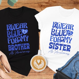 May include: Two t-shirts with the text "I wear blue for my brother/sister" and "ALS Awareness". The shirts are black and white with blue accents.