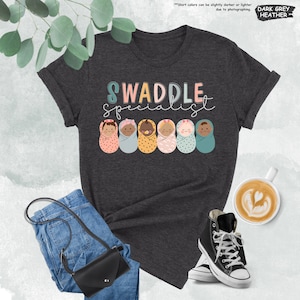 a t - shirt with the words swaddle spelled on it