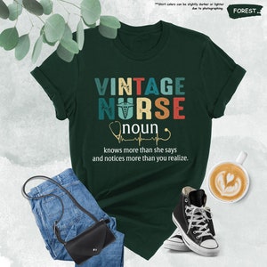 a t - shirt that says vintage nurse and a pair of jeans