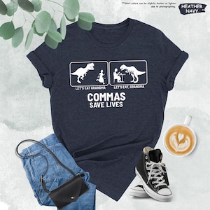 a t - shirt that says commas save lives with a picture of a dinosaur