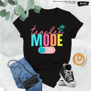 May include: Black t-shirt with the text "teacher MODE OFF" in colorful letters with light bulbs around the letters. The text "OFF" is on a pink button with a power symbol.