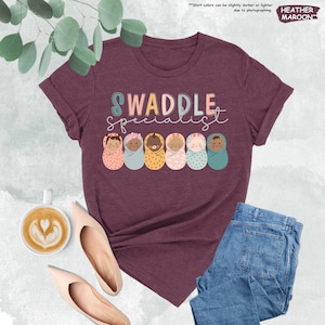 a t - shirt that says swaddle with donuts on it
