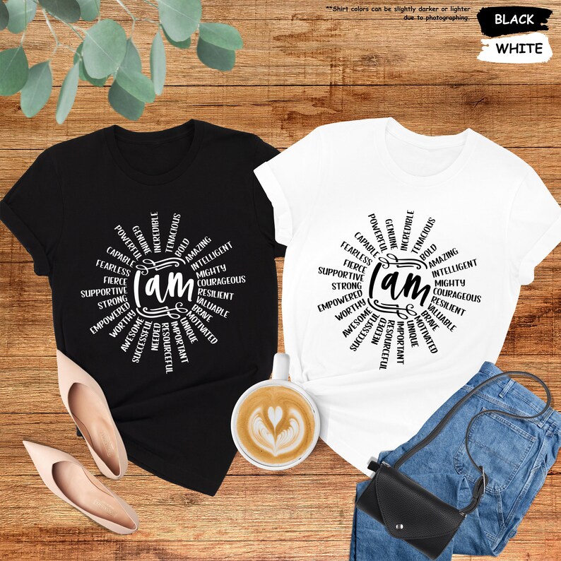 a couple of t - shirts sitting on top of a wooden table