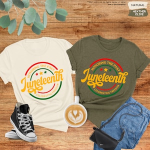 a couple of t - shirts sitting on top of a wooden floor