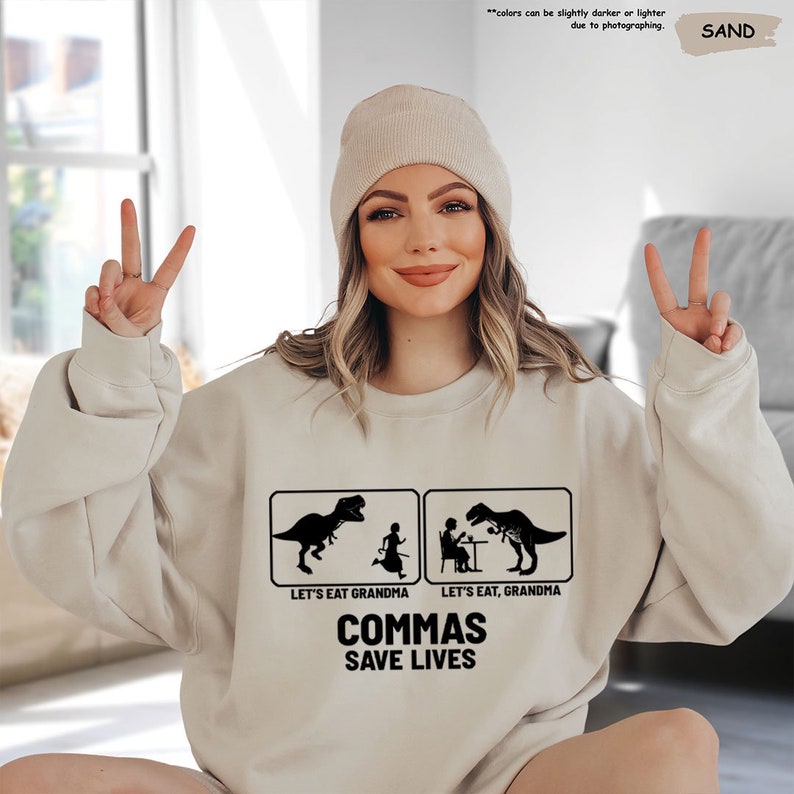 a woman wearing a sweatshirt that says commas save lives