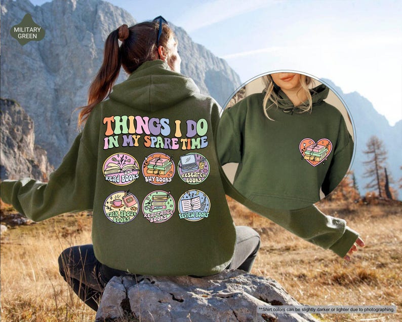 a woman sitting on a rock wearing a green hoodie