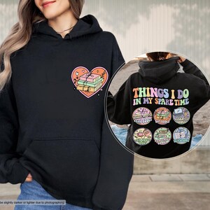 a woman wearing a black hoodie with the words things i do in my spare