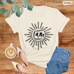 a t - shirt with the words on it next to a cup of coffee